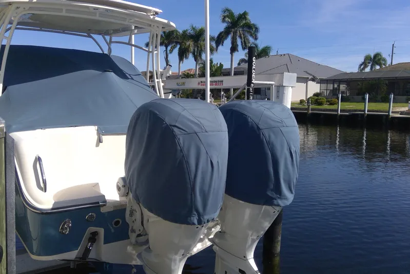  Yacht Photos Pics 2023 Grady-White Freedom 285 boat docked, covered engines, sunny day, waterfront view.