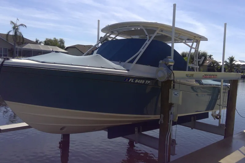  Yacht Photos Pics 2023 Grady-White Freedom 285 boat on lift by waterfront homes.