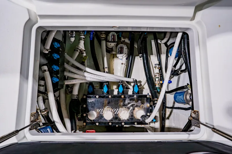  Yacht Photos Pics Engine compartment of a 2012 Yellowfin 39 Offshore boat, showcasing complex plumbing and wiring.
