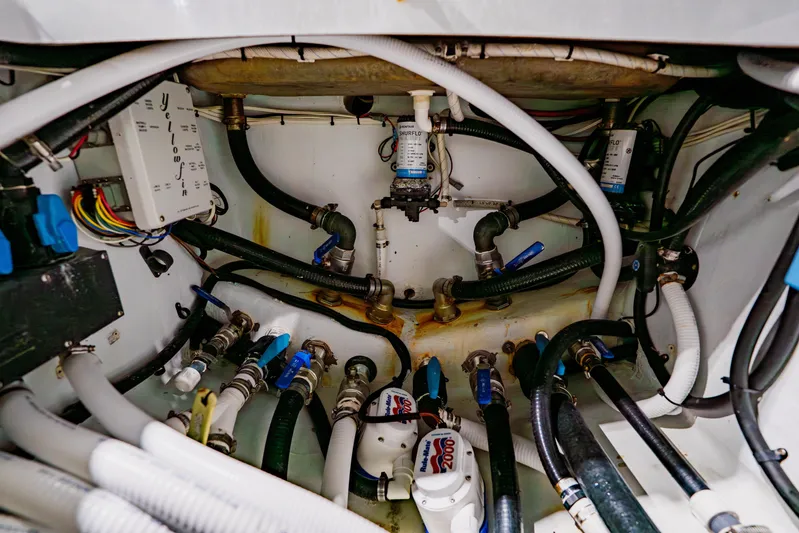  Yacht Photos Pics Engine compartment of a 2012 Yellowfin 39 Offshore boat, showcasing hoses and wiring.