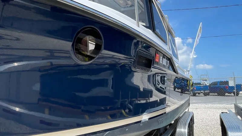  Yacht Photos Pics 2022 Ranger Tugs R-25 boat, blue hull, docked outdoors under a clear sky.