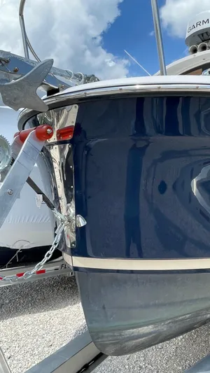  Yacht Photos Pics 2022 Ranger Tugs R-25 boat bow with anchor, blue hull, and clear sky background.