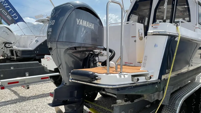  Yacht Photos Pics 2022 Ranger Tugs R-25 with Yamaha outboard motor, docked on a trailer.