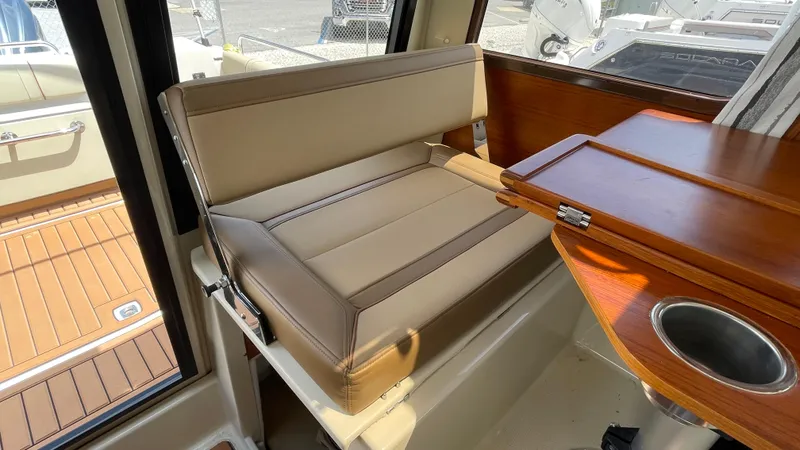  Yacht Photos Pics Interior seating of 2022 Ranger Tugs R-25 boat with foldable table and cup holder.