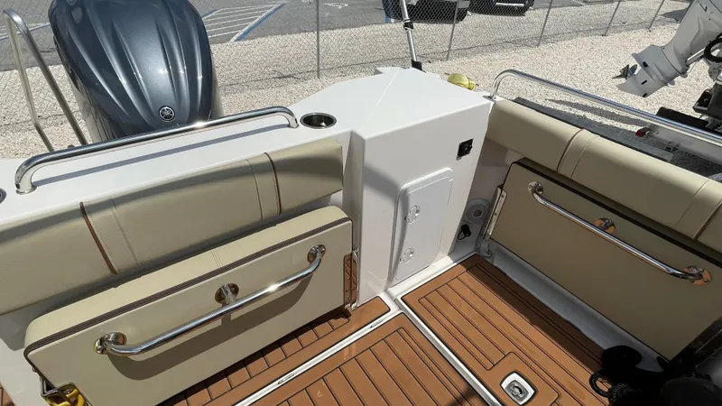  Yacht Photos Pics 2022 Ranger Tugs R-25 boat interior with beige seating and wood flooring.