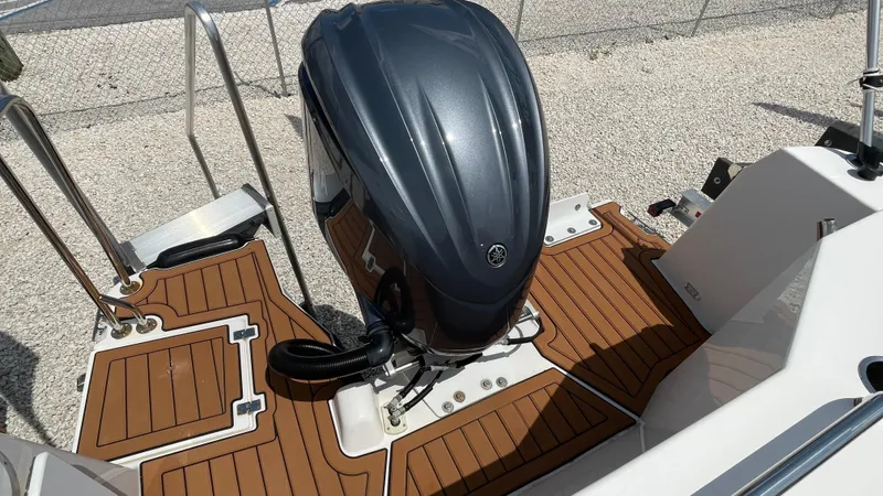  Yacht Photos Pics 2022 Ranger Tugs R-25 boat with outboard motor and teak deck flooring.