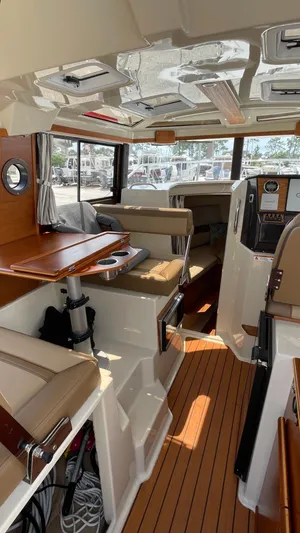  Yacht Photos Pics Interior of 2022 Ranger Tugs R-25 boat with wood accents and seating.