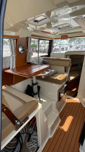  Yacht Photos Pics Interior of 2022 Ranger Tugs R-25 boat with seating and wooden accents.