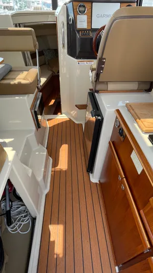  Yacht Photos Pics 2022 Ranger Tugs R-25 interior with wood flooring and modern navigation equipment.