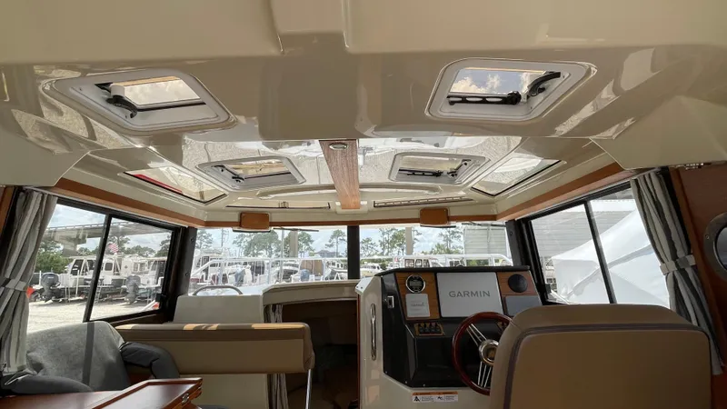  Yacht Photos Pics Interior of 2022 Ranger Tugs R-25 boat with modern helm and seating area.