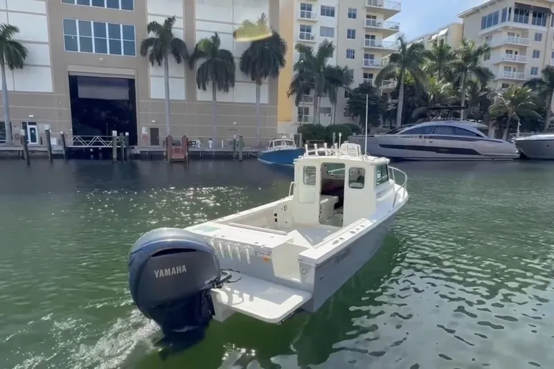  Yacht Photos Pics 2023 Parker 2320 Sport Cabin boat with Yamaha engine in marina setting.