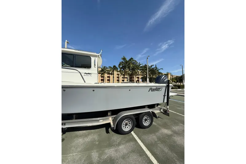  Yacht Photos Pics 2023 Parker 2320 Sport Cabin boat on trailer in sunny parking lot.