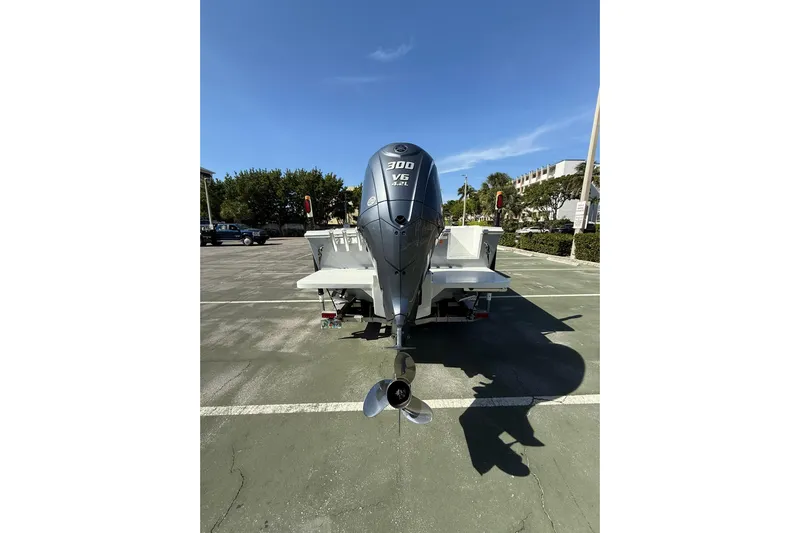  Yacht Photos Pics 2023 Parker 2320 Sport Cabin boat with powerful outboard motor in a parking lot.