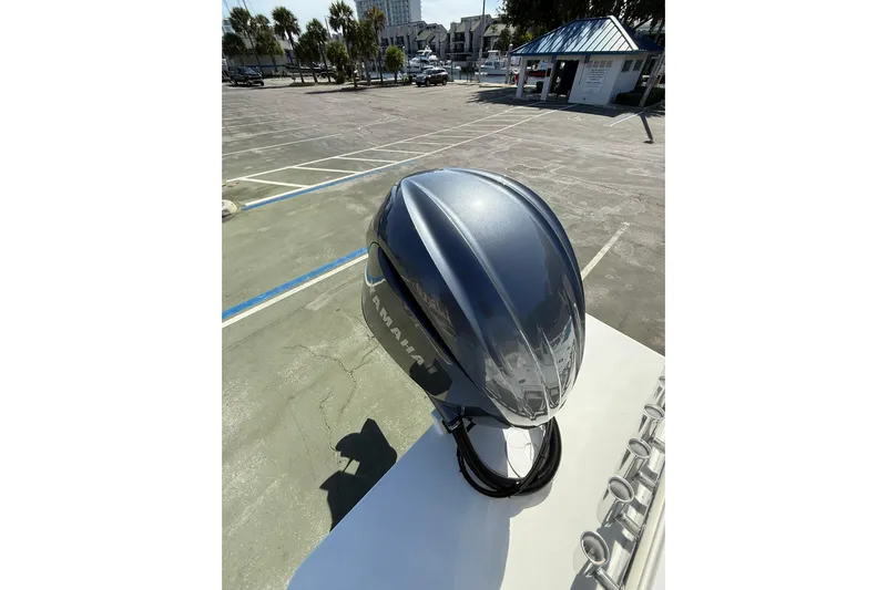  Yacht Photos Pics 2023 Parker 2320 Sport Cabin with Yamaha outboard in a sunny parking lot.