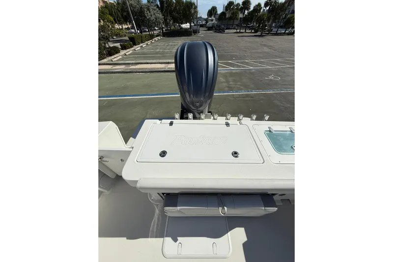  Yacht Photos Pics 2023 Parker 2320 Sport Cabin boat with outboard motor in parking lot.