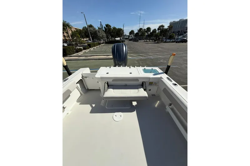  Yacht Photos Pics 2023 Parker 2320 Sport Cabin boat deck with seating and motor in a parking lot.
