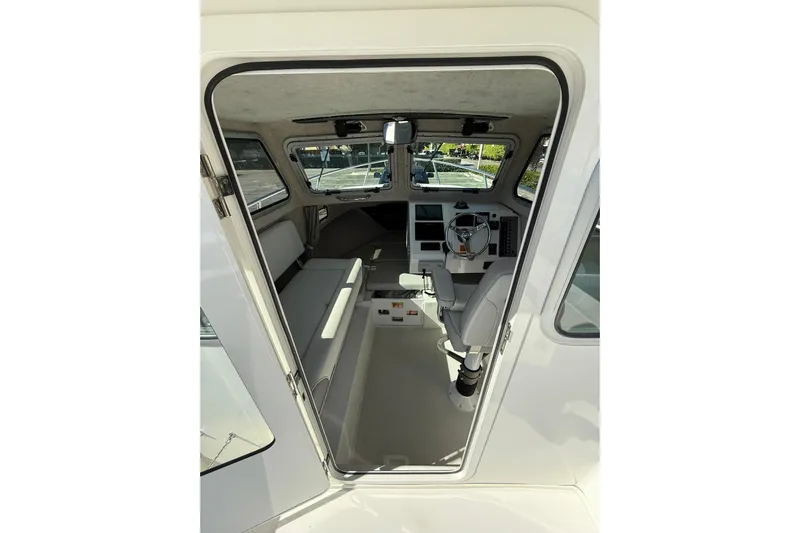  Yacht Photos Pics Interior view of 2023 Parker 2320 Sport Cabin boat, featuring helm and seating area.