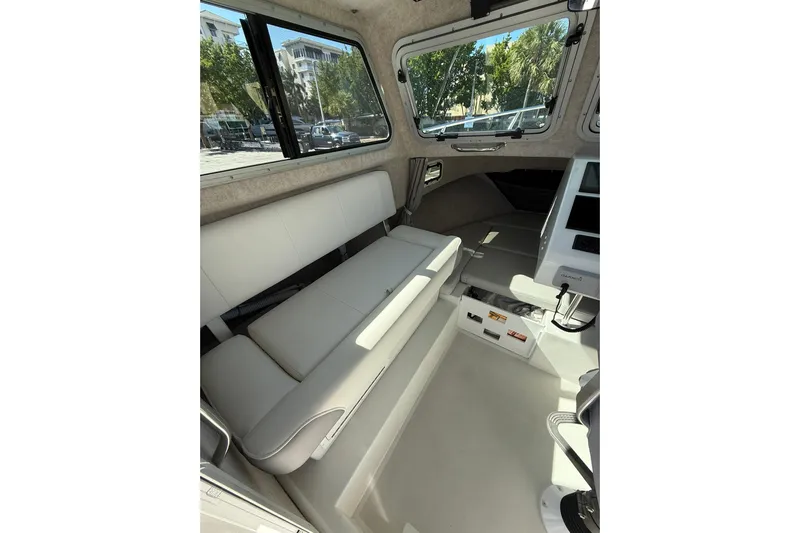  Yacht Photos Pics Interior of 2023 Parker 2320 Sport Cabin, featuring seating and navigation equipment.
