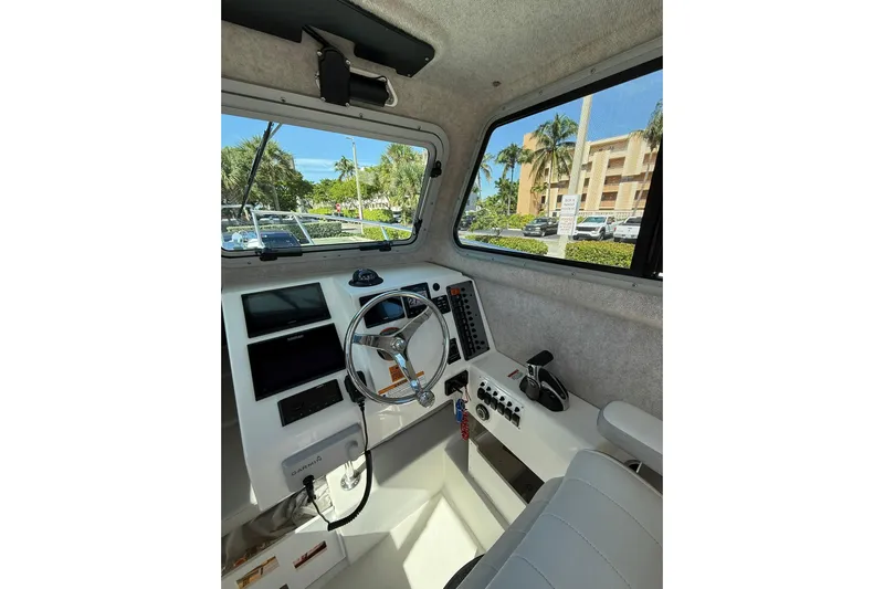  Yacht Photos Pics 2023 Parker 2320 Sport Cabin interior with steering wheel and control panel.