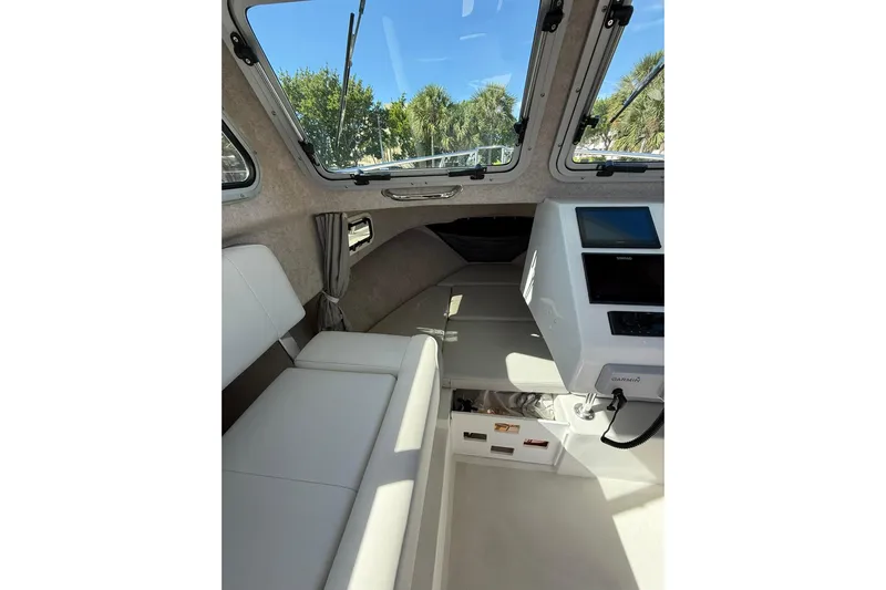  Yacht Photos Pics 2023 Parker 2320 Sport Cabin interior with seating and navigation equipment.