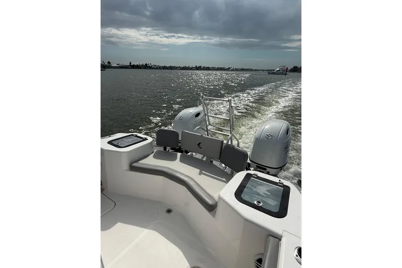  Yacht Photos Pics 2026 Falcon Boats 26 cruising on a sunny day, showcasing dual engines and sleek design.