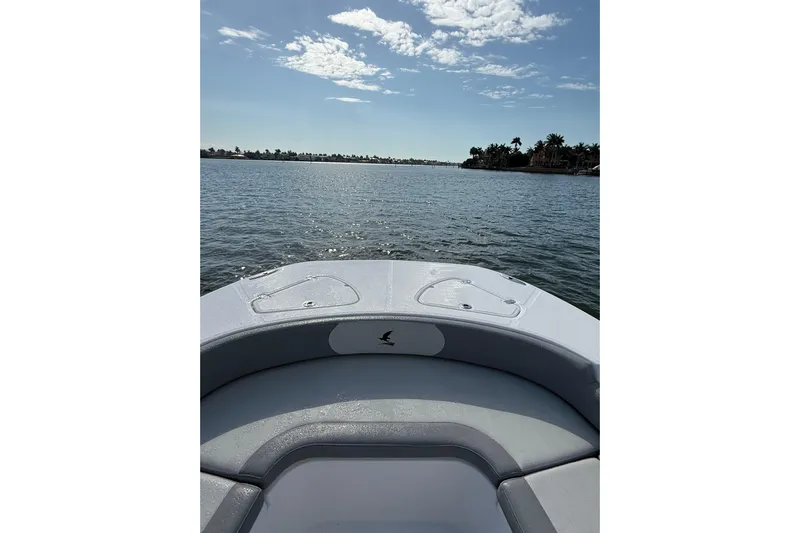  Yacht Photos Pics Bow view of 2026 Falcon Boats 26 on a sunny day, calm waters ahead.