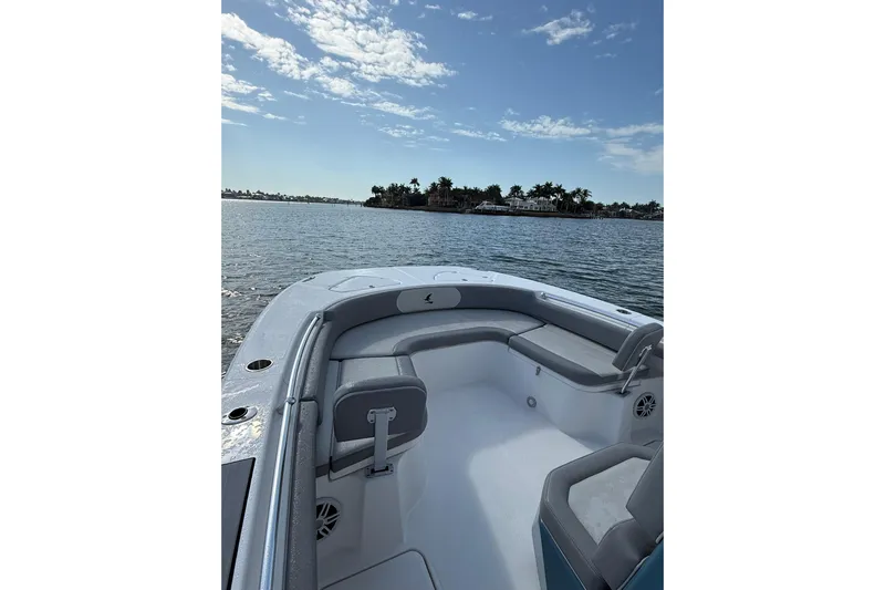  Yacht Photos Pics 2026 Falcon Boats 26 on calm water, featuring spacious seating and scenic view.