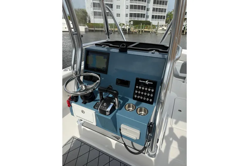  Yacht Photos Pics Control panel of 2026 Falcon Boats 26, featuring steering wheel and navigation system.