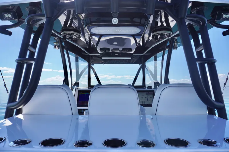  Yacht Photos Pics 2019 SeaHunter 45 Tournament boat interior with helm and seating, under clear blue sky.