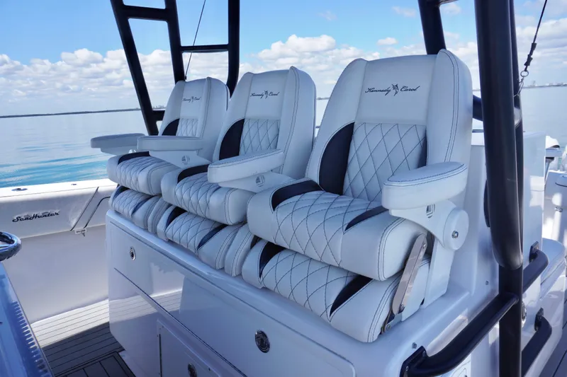  Yacht Photos Pics 2019 SeaHunter 45 Tournament boat with luxurious white and black seating, calm water backdrop.