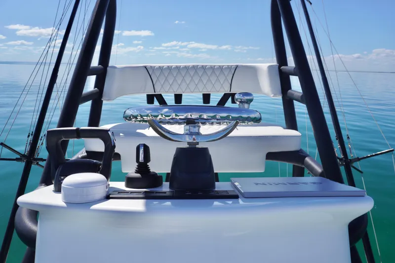  Yacht Photos Pics 2019 SeaHunter 45 Tournament helm with steering wheel and navigation equipment on calm water.