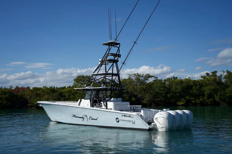  Yacht Photos Pics 2019 SeaHunter 45 Tournament boat with multiple engines on calm water, surrounded by greenery.