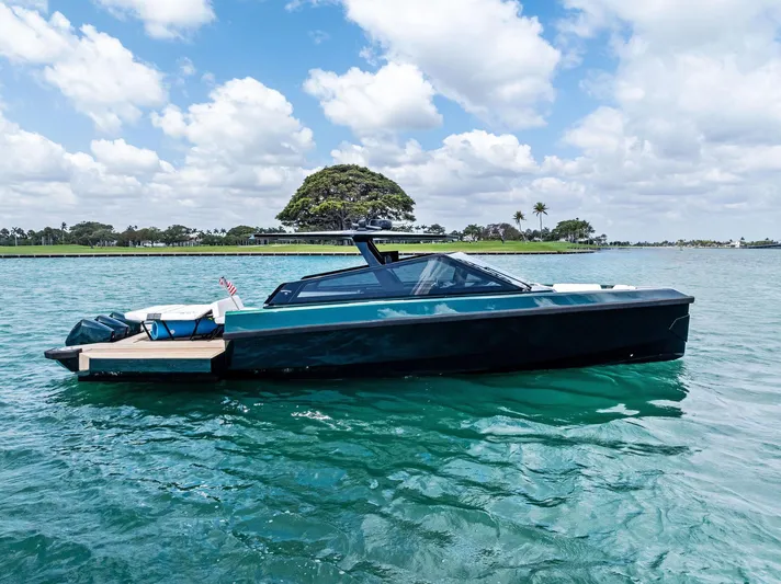 Green Eyes Yacht Photos Pics 2023 Wally Wallytender 43X yacht on calm water under a partly cloudy sky.