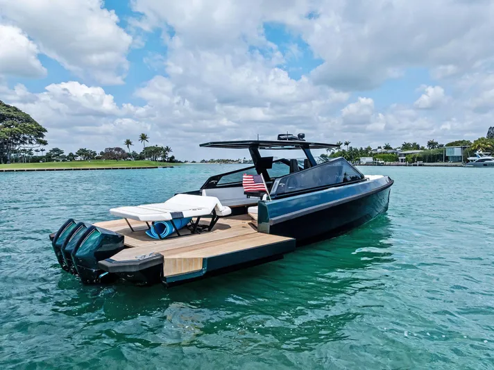 Green Eyes Yacht Photos Pics 2023 Wally Wallytender 43X luxury yacht on serene water under a partly cloudy sky.