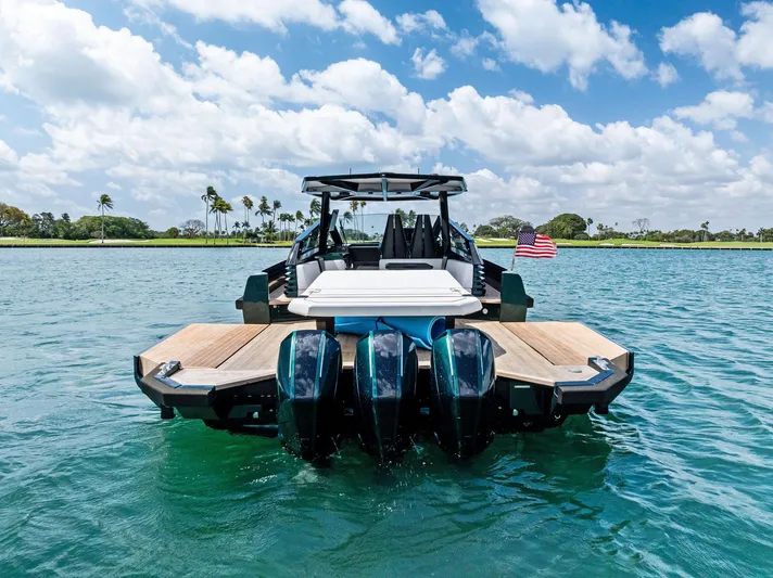 Green Eyes Yacht Photos Pics 2023 Wally Wallytender 43X yacht on clear blue water, rear view.