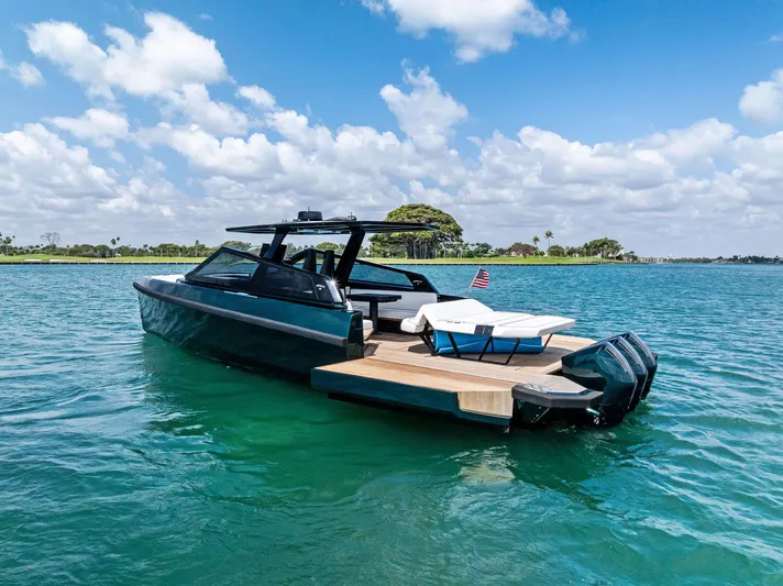 Green Eyes Yacht Photos Pics 2023 Wally Wallytender 43X yacht on clear blue water under a sunny sky.