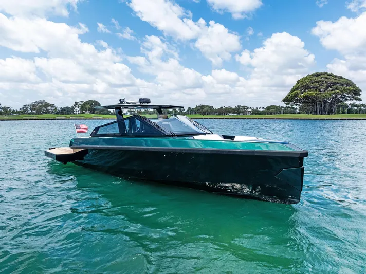 Green Eyes Yacht Photos Pics 2023 Wally Wallytender 43X yacht on serene water under blue sky.