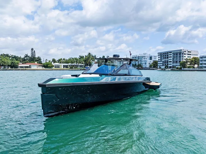 Green Eyes Yacht Photos Pics 2023 Wally Wallytender 43X yacht on calm water, modern design, clear sky background.