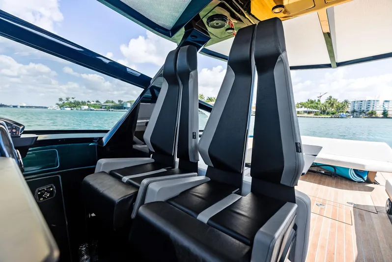 Green Eyes Yacht Photos Pics Interior of 2023 Wally Wallytender 43X yacht with modern seating and scenic water view.