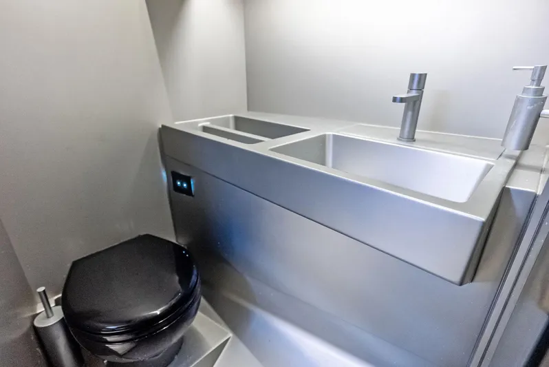 Green Eyes Yacht Photos Pics Modern bathroom interior of 2023 Wally Wallytender 43X yacht, featuring sleek fixtures and dual sinks.