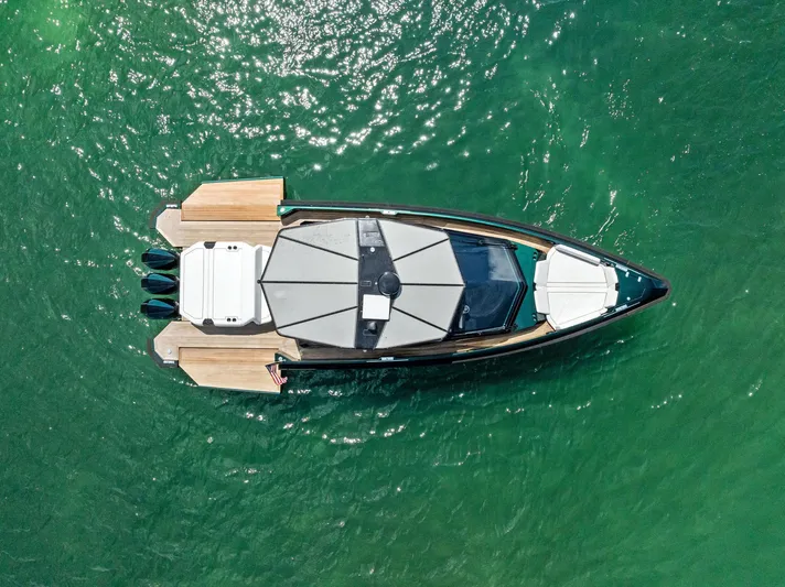 Green Eyes Yacht Photos Pics 2023 Wally Wallytender 43X yacht on clear green water, aerial view.