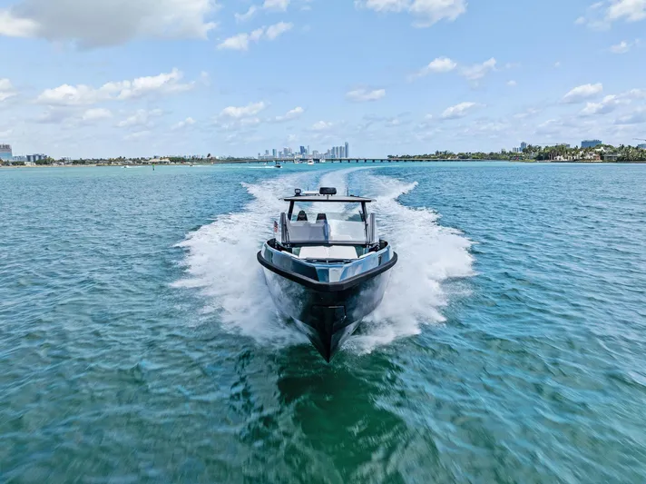 Green Eyes Yacht Photos Pics 2023 Wally Wallytender 43X cruising on clear blue water under a sunny sky.
