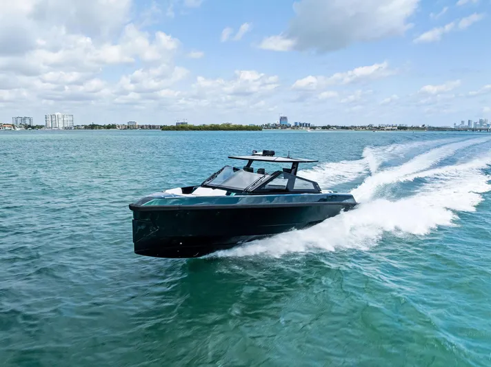 Green Eyes Yacht Photos Pics 2023 Wally Wallytender 43X cruising on open water under a partly cloudy sky.