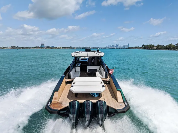 Green Eyes Yacht Photos Pics 2023 Wally Wallytender 43X cruising on clear blue water, showcasing sleek design and powerful engines.