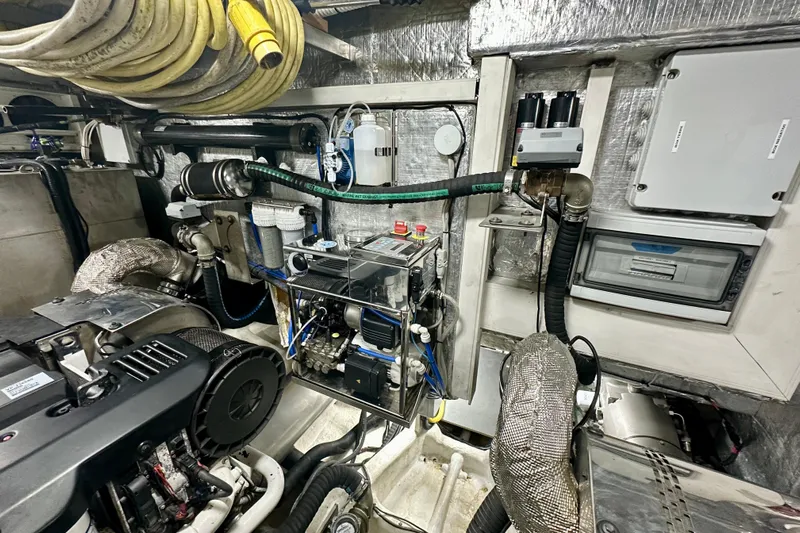  Yacht Photos Pics Engine room of a 2016 Absolute 72 FLY yacht with mechanical equipment and hoses.