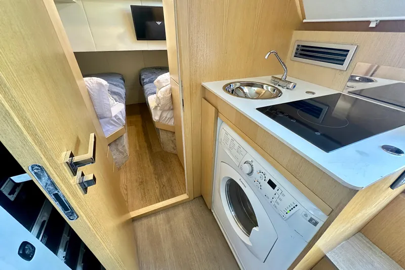  Yacht Photos Pics Compact kitchen and bedroom in 2016 Absolute 72 FLY yacht, featuring modern amenities.