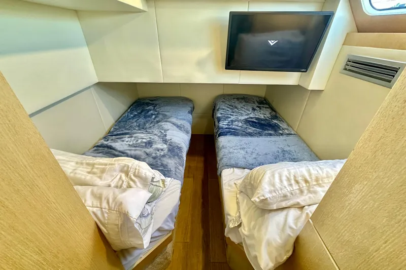  Yacht Photos Pics Twin beds in a cozy cabin of a 2016 Absolute 72 FLY yacht.