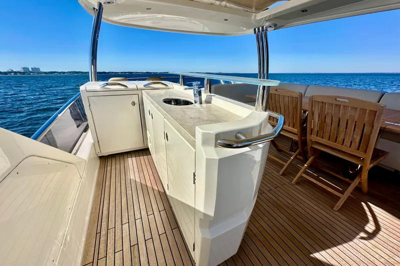  Yacht Photos Pics Luxurious 2016 Absolute 72 FLY yacht deck with outdoor kitchen and seating, overlooking the ocean.