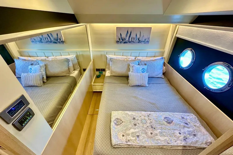  Yacht Photos Pics Luxurious bedroom interior of 2016 Absolute 72 FLY yacht with elegant bedding and porthole windows.