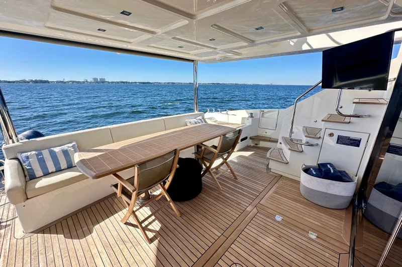  Yacht Photos Pics Luxurious 2016 Absolute 72 FLY yacht deck with seating, table, and ocean view.